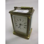 Small early 20th Century gilt brass cased carriage clock with enamel dial and Roman numerals and a