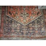 Kurdish rug with medallion and all-over stylised geometric designs on a red / brown ground with