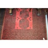 Afghan rug with single row of gols on a typical red ground with borders