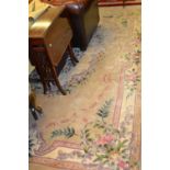 Chinese rug with embossed floral design on beige ground