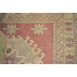 Turkish rug of geometric centre medallion design and multiple borders on a beige ground