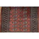 Pakistan Bokhara rug on rust ground with multiple borders, 4ft x 3ft,