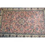 Similar Indo Persian rug with stylised floral design on a pink ground