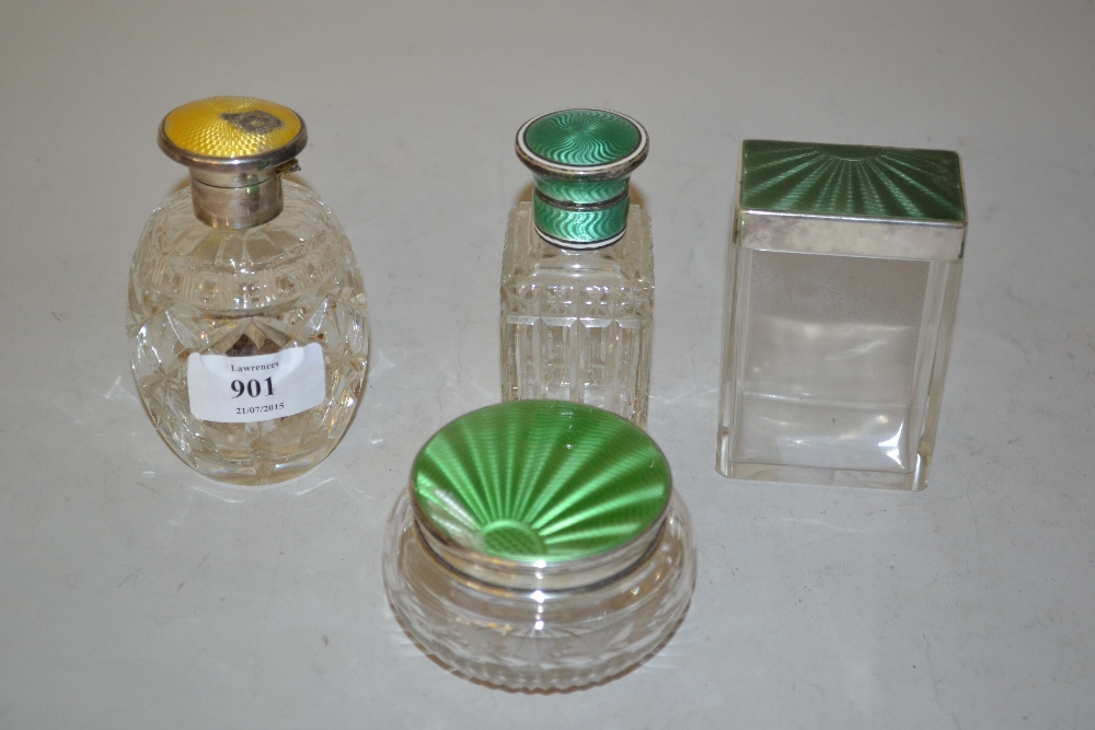 Four various silver and enamel decorated glass dressing table bottles