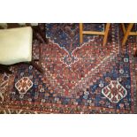 Shiraz carpet with centre medallion and all-over floral design with multiple borders,