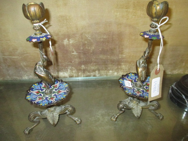 Pair of gilt bronze and champleve enamel candlesticks with stork supports