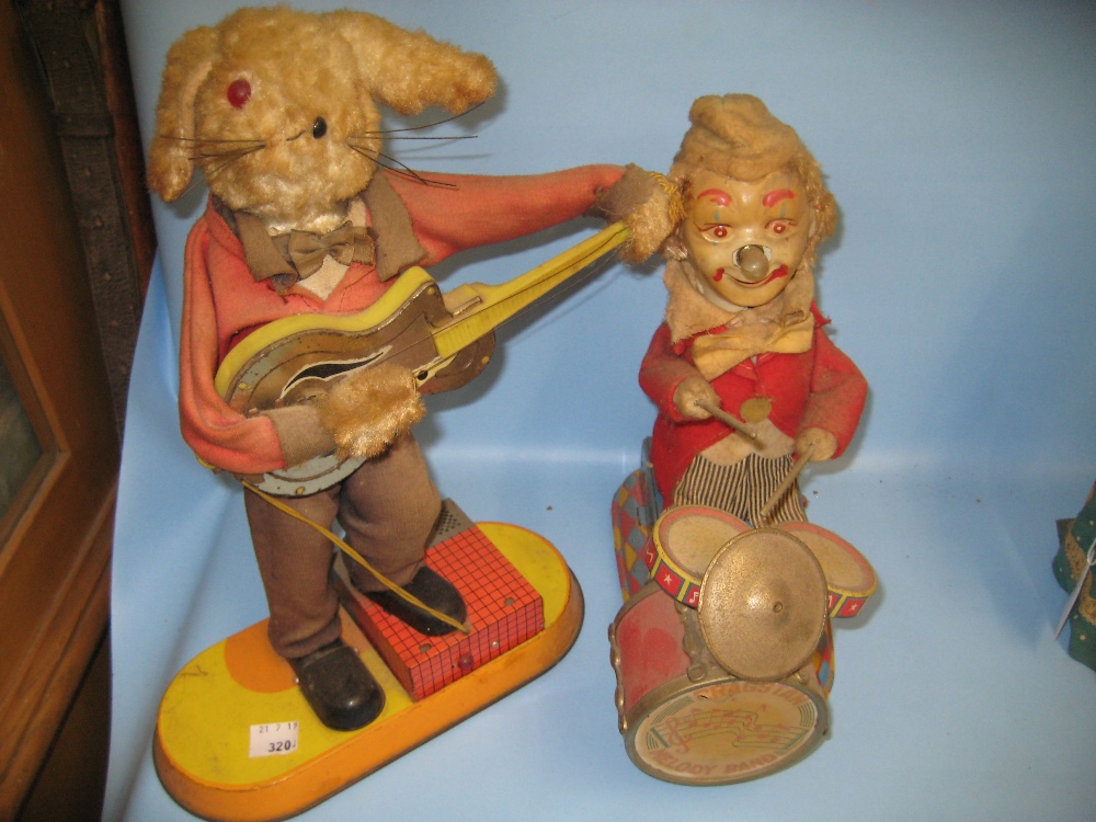 Two battery operated tin plate figures,