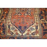 Kelim flat weave rug with geometric decoration on a dark blue ground,