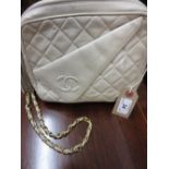 Ladies Chanel quilted cream leather shoulder bag with a gilt metal strap