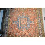 Karaja runner with repeating stylised medallion and all-over floral design on a brick red ground