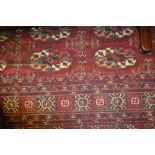 Large Bokhara pattern machine made carpet on a dark red ground,