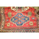 Modern Kazak style rug with geometric medallion design on red ground with borders