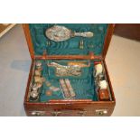 Late Victorian ladies embossed leather simulated crocodile skin dressing case containing silver