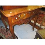 18th Century French walnut side table with shaped moulded top above a single drawer and carved