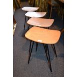 Set of four 1960's shaped laminate topped stools on black painted metal supports