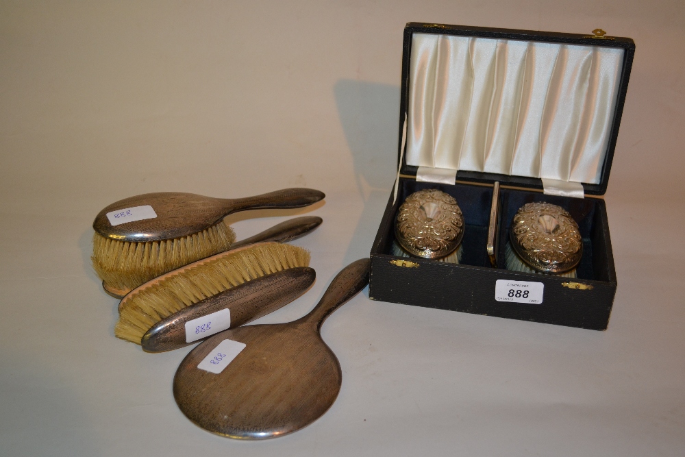 Five various silver backed mirrors and brushes together with a cased pair of silver backed brushes