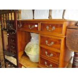 Reproduction yew wood pedestal desk having green leather inset top above an arrangement of nine