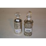 Two glass perfume bottles with silver holders,