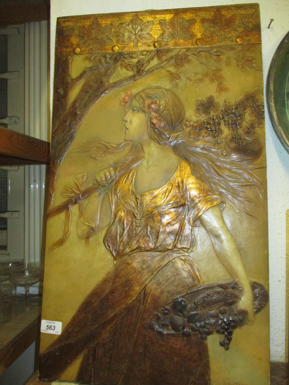 Late 19th or early 20th Century Austrian terracotta wall plaque depicting a girl grape harvester,