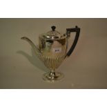 Late Victorian silver coffee pot of oval half fluted pedestal form with ebonised handle, Sheffield,