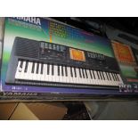 Boxed Yamaha Portatone electric keyboard with stand