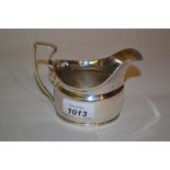 George III silver cream jug of plain oval design with shaped handle,