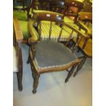 Victorian oak smokers bow chair with spindle back and padded seat