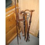 Folding easel, two shooting sticks, various walking sticks etc.