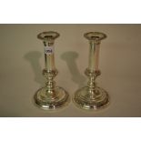 Pair of 19th Century plate on copper candlesticks with circular embossed decorated bases