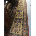 Turkish Persian design runner with multiple centre medallions and borders on a beige ground,