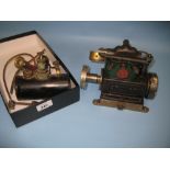 Small stationary engine by Stewart Sirius and a small black painted boiler with pressure gauge