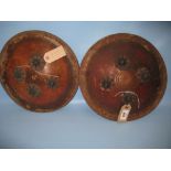 Two small leather circular metal studded and gilt decorated shields