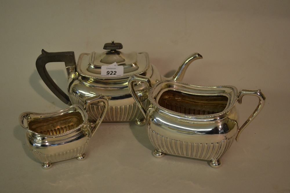 Edwardian silver three piece tea service of rectangular baluster half fluted design with bun feet,