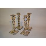 Set of four George IV silver candlesticks, the knopped baluster stems above square shaped bases,