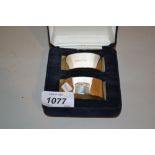 Cased pair of modern silver napkin rings,