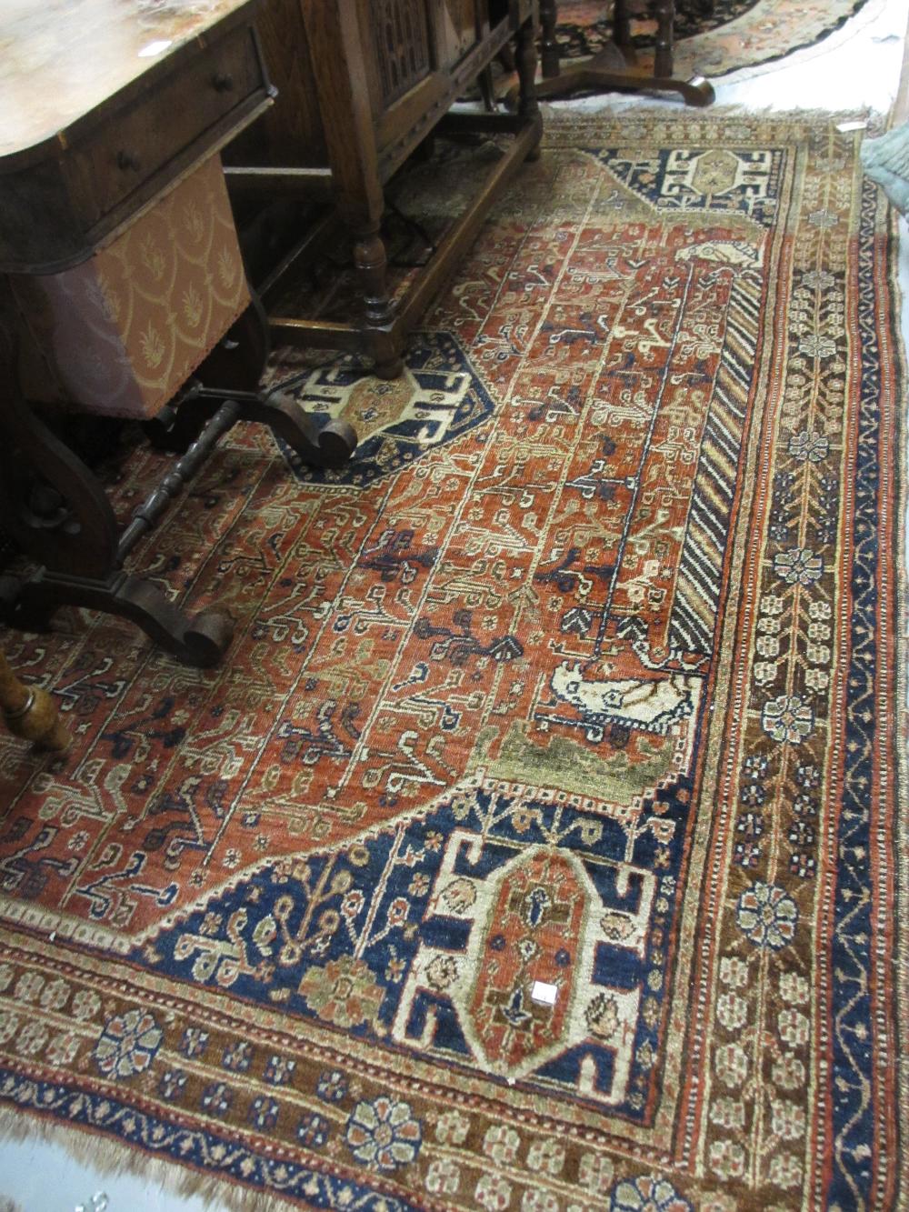 Shiraz rug with centre medallion and multiple borders on a wine ground (worn),