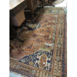 Shiraz rug with centre medallion and multiple borders on a wine ground (worn),