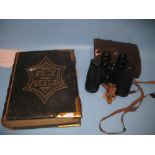 Leather bound and brass mounted family bible and a cased pair of Prinz 10 x 50 binoculars