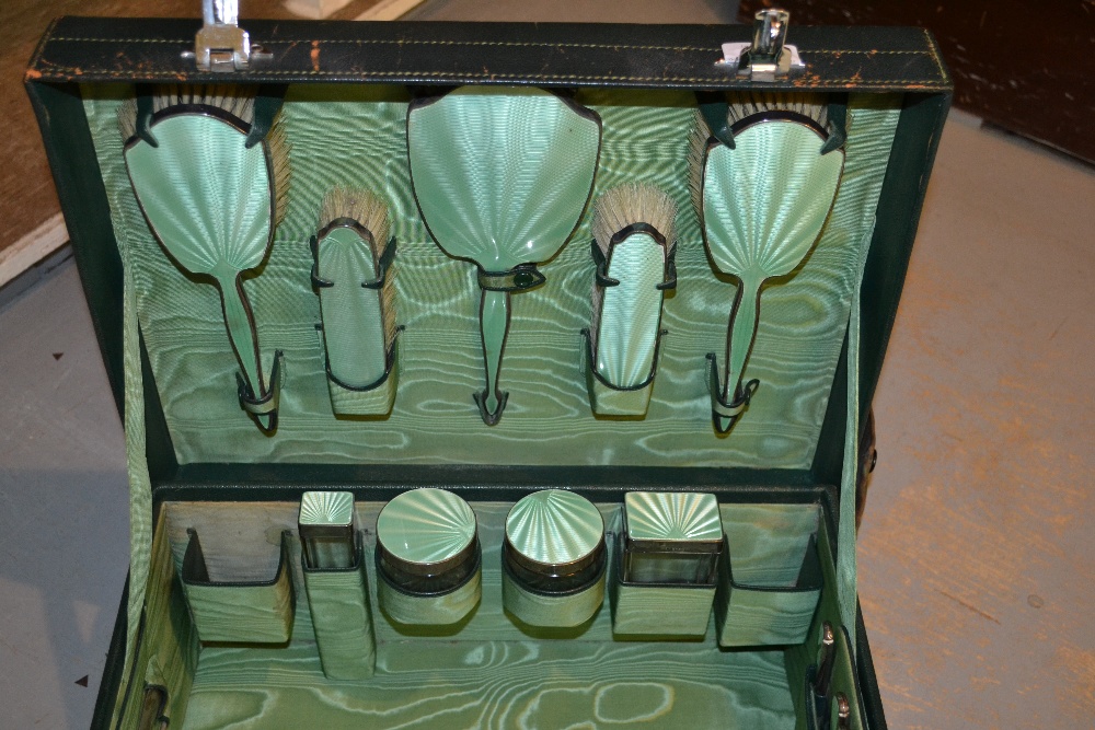 Birmingham silver and green enamel travel dressing set comprising  fifteen pieces in original green