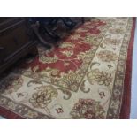 Large rug having all-over floral design with borders on a cream and burgundy ground together with