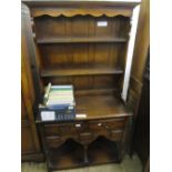 20th Century oak dresser having moulded top above shelved back above an arrangement of five short