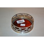 Circular plated and tortoiseshell bottle coaster decorated with swags