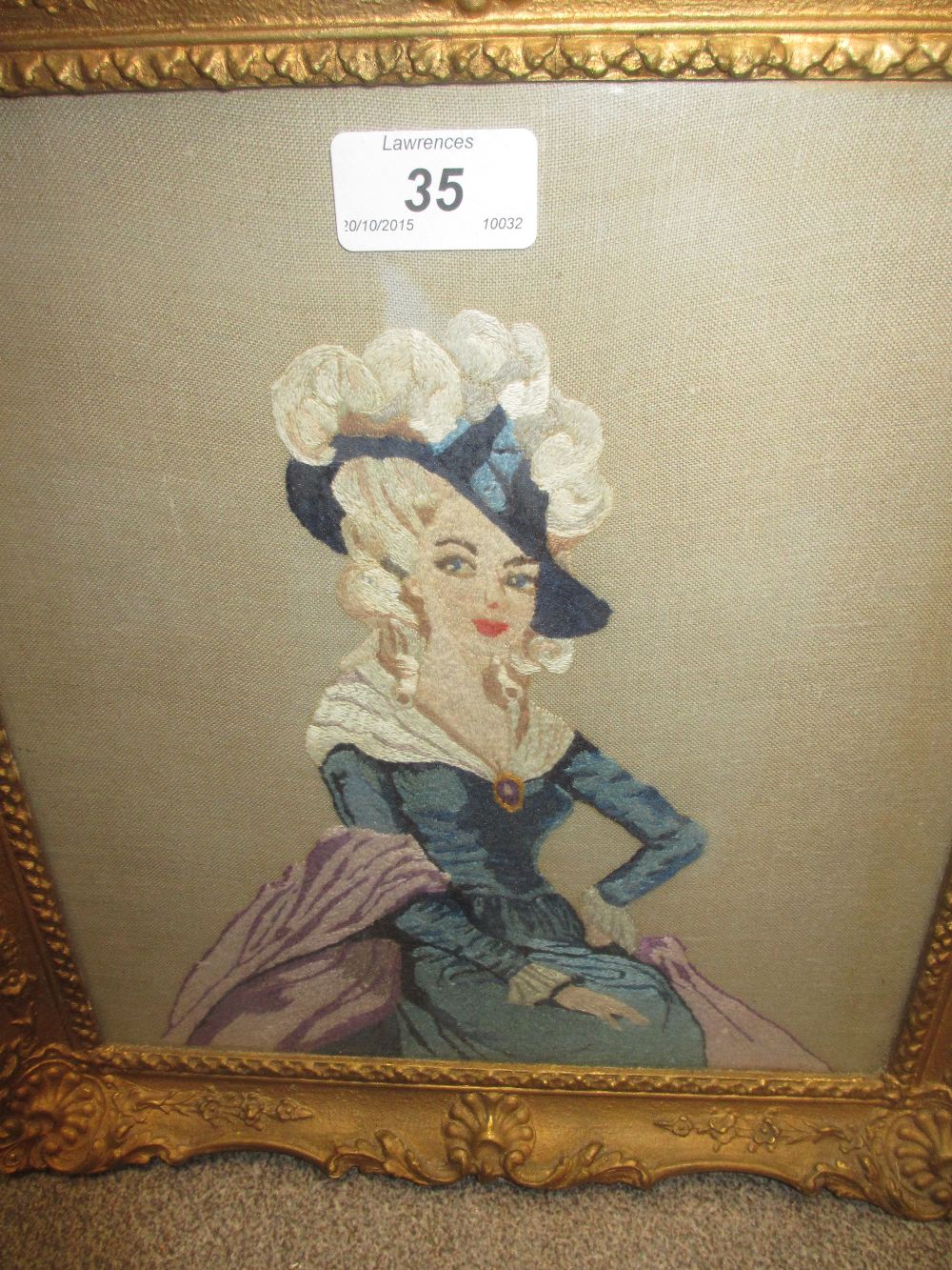 1920's Gilt framed silk work portrait of a lady together with a gilt framed woolwork still life