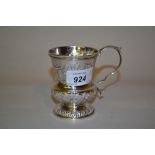 George IV Irish silver Christening mug of embossed knopped baluster form with scroll handle,