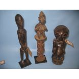 Group of three various African carved hardwood tribal figures,