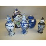 Pair of Chinese blue and white baluster form vases with covers,