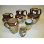 Graduated set of three Royal Doulton stoneware jugs, similar mug,