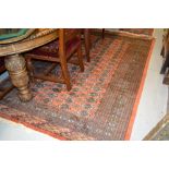 Pakistan Bokhara pattern rug on a terracotta ground together with a similar small runner