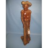 Large modern carved wooden figure of an oriental man sweeping,