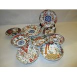 Two Imari plates and seven similar dishes all decorated in conventional iron red, blue,